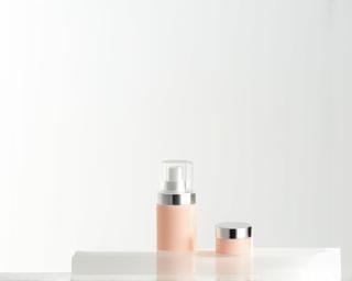 Clean commercial product photo example of a cosmetic bottle on a white background with soft shadows.