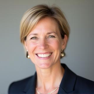 Headshot of Ingrid Larsen, a woman with short hair smiling.
